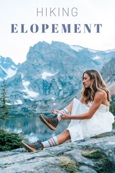 a woman sitting on top of a mountain next to a lake with the words hiking equipment