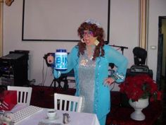 a woman standing in front of a table with a can on it's face