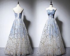 two dresses on mannequins, one in blue and the other in white