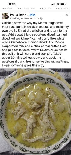 a bowl filled with chicken and broth sitting on top of a table