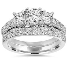 three stone engagement ring set with matching wedding band and diamond accents on the shoulders, in white gold