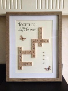 a wooden frame with scrabbles and butterflies on it