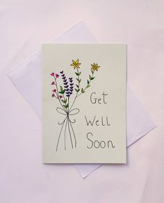 a card with flowers on it that says get well soon