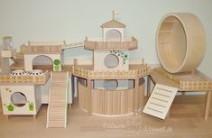 a wooden toy house with stairs and towers