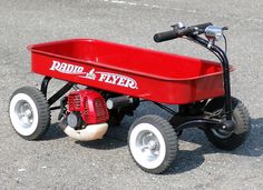 a red radio flyer wagon sitting on the ground