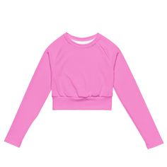 This super sweet pink long-sleeve crop top from Extremely Stoked®️ is made of a smooth, good feeling, recycled polyester and elastane, making it an eco-friendly choice for swimming, sports, or athleisure outfits. The crop top has a tear-away care label and a wide, double-layered waistline band for a super comfy fit.• UPF 50+• Trendy, cropped fit• Wide, double-layered waistline band• Raglan sleeves• Tear-away care label• Size up if you’re between sizes as this fabric can be tight on the bodyThis Pink Long Sleeve Crop Top, Athletic Shorts Women, Compression Wear, Athletic Swimwear, Plus Size Workout, Flared Leggings, Pink Crop Top, Cropped Tops, Athleisure Outfits