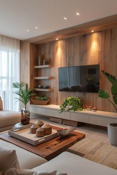 a living room filled with furniture and a flat screen tv mounted on a wall next to a window