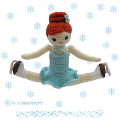 a crocheted doll is in the air with snowflakes