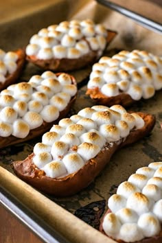 someone is cutting into some bread with marshmallows on top