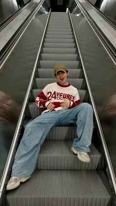 a man sitting on an escalator with his legs crossed