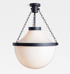 a white light hanging from a chain on a ceiling fixture with an oval glass shade