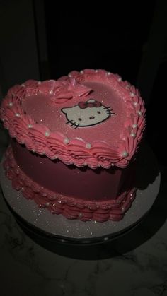 a hello kitty cake with pink frosting on top