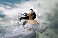 a woman is floating in the water with her hair blowing back and looking into the sky