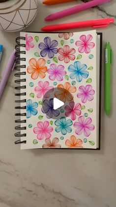 an open notebook with colorful flowers on it