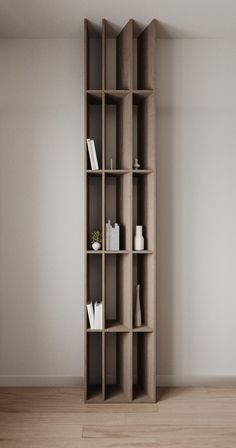 an empty bookcase in the corner of a room with white walls and wooden floors