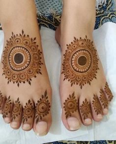 the feet are decorated with hendi designs on it's hands and feet, as well as an intricate circular motif