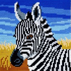 a cross stitch picture of a zebra in a field with blue sky and clouds behind it