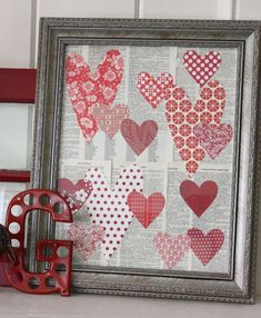 an old book page with hearts on it and a red metal object next to it