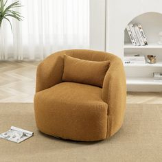 an orange chair sitting on top of a rug next to a book shelf