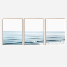 three framed photographs of the ocean with waves