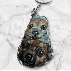 a keychain with a dog on it's face and two different eyes