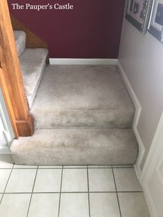 a carpeted stair case in a house with purple walls and white tile flooring