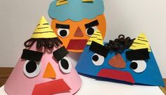 three paper hats with angry birds on them sitting on top of a white table next to each other