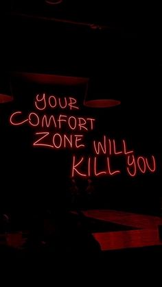 a neon sign that says your comfort zone will kill you