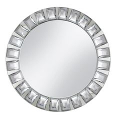 a round mirror that is made out of silver foil and has geometric designs on it