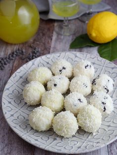 a white plate topped with cookies next to lemons