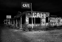 black and white photograph of an abandoned cafe