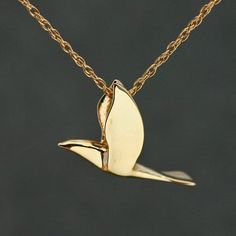 This beautiful dove is carved in full dimension all the way around.  It has a finish polish on both sides. It is graceful, elegant and spiritual.And it is a pendant that is done and ready to ship.It measures approximately 3/4" tall and 3/4" wide.  It is made in solid 14k yellow gold.I have this dove design available in two sizes (see 4th picture), as well as in sterling silver.  This particular pendant is the smaller of the two sizes.  The larger one is 1" x 1" and please see elsewhere in our sh Dove Design, Dove Pendant, Disc Pendant, Arrow Necklace, Necklace Lengths, Two By Two, Gold Necklace, Yellow Gold, Pendant Necklace