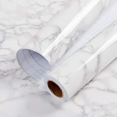 two rolls of white marble paper sitting on top of each other with the words bpa free