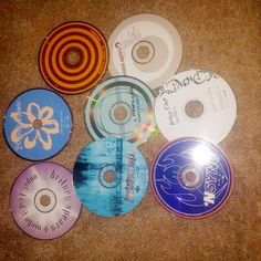 several cds are laying on the floor next to each other