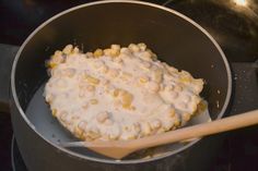 a pan filled with food and a wooden spoon