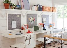 a desk with a laptop computer on top of it next to a chair and table