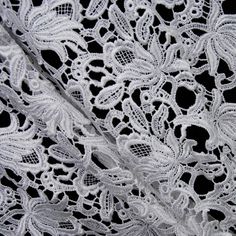 white lace with flowers and leaves on black background