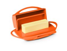 an orange lunch box with a soap bar in it