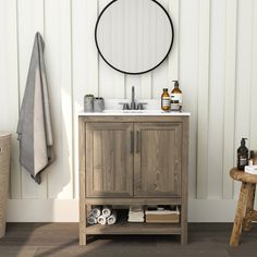 a bathroom with a sink, mirror and towel rack