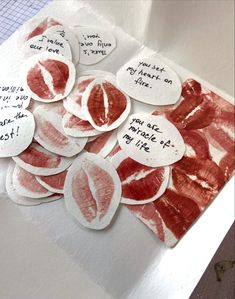 several pieces of paper that have been cut into heart shapes with words written on them