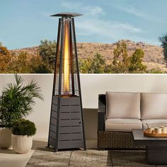 an outdoor patio heater sitting next to a couch