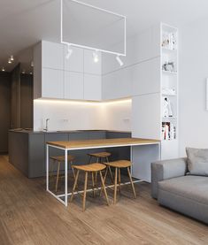 an open kitchen and living room are shown in this modern style apartment with white walls