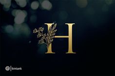 the letter h is made up of leaves and flowers on a dark background with boke