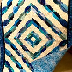 a blue and white quilt is on display