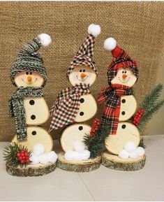 three snowmen are standing next to each other in front of a burlock