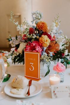 a table with flowers and candles on it