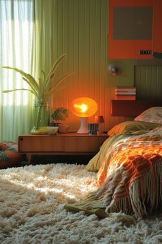 a bedroom with an orange lamp on the side table next to a bed and rug