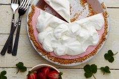 a pie with two slices taken out of it and some strawberries on the side