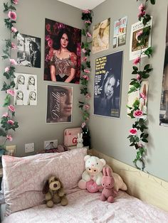 a bedroom with pink flowers and pictures on the wall