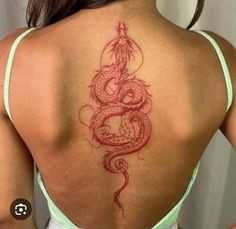 a woman with a dragon tattoo on her back